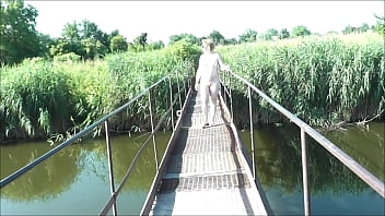 Preview 1 of Anal Escort Uk - Summer nostalgia. Dressed in sun. Sexy naked woman MILF walks on hanging bridge of river. Nudists. Naturists. Nude beach. Music erotic clip.