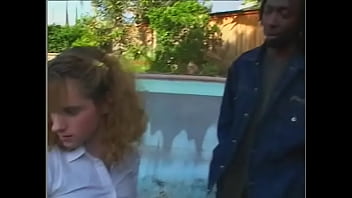 Preview 1 of Besin Jarman Adult Star - Young curly chick in a short skirt sucks two black dicks near the pool