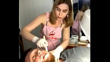 Preview 1 of Doll Cax - Classy blonde waxes a man&#039_s face,  her gorgeous breasts popping out