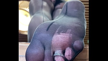 Preview 1 of Real Momet - Goddess with long legs and big ass in black pantyhose on the table plays with a toe ring above your face