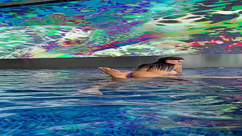 Preview 2 of Sixi Full Video - Monika Fox In Purple Bikini Swims In Pool &amp_ Poses By Window Against Background Of City (Free)