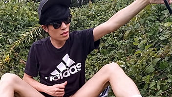 Preview 3 of Shemale While - Jon Arteen,  a gay Asian twink,  is dressed in an Adidas t-shirt,  hot pants,  white socks,  and Duramo sneakers. He jerks off his shaved cock and ejaculates thick cum outdoors.