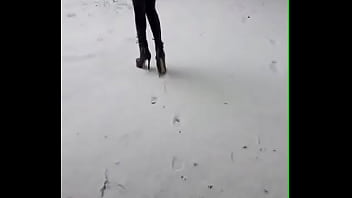 Preview 2 of Mom And Son Reb - Walking on the snow with leather catsuit and ankle Platform boots. You can see my long legs and beautiful ass