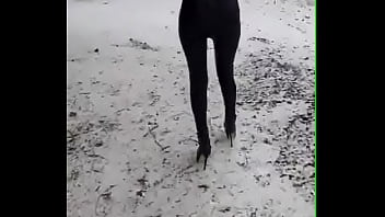 Preview 1 of Mom And Son Reb - Walking on the snow with leather catsuit and ankle Platform boots. You can see my long legs and beautiful ass