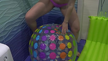 Preview 1 of French Gay Young - A curvy milf pisses and spits on a large inflatable ball and on a beach massage. Masturbating hairy pussy. Dirty fetish with urine and drool from a mature blonde with a big ass. PAWG.